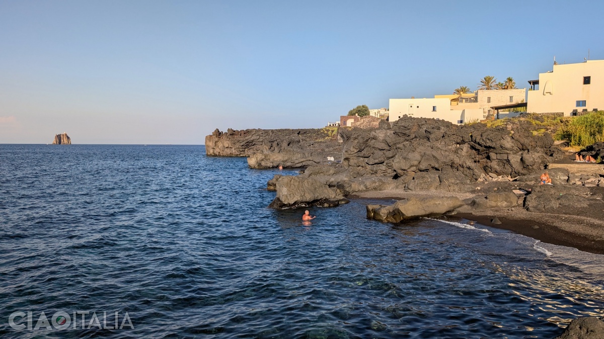 The white houses contrast with the dark soil.