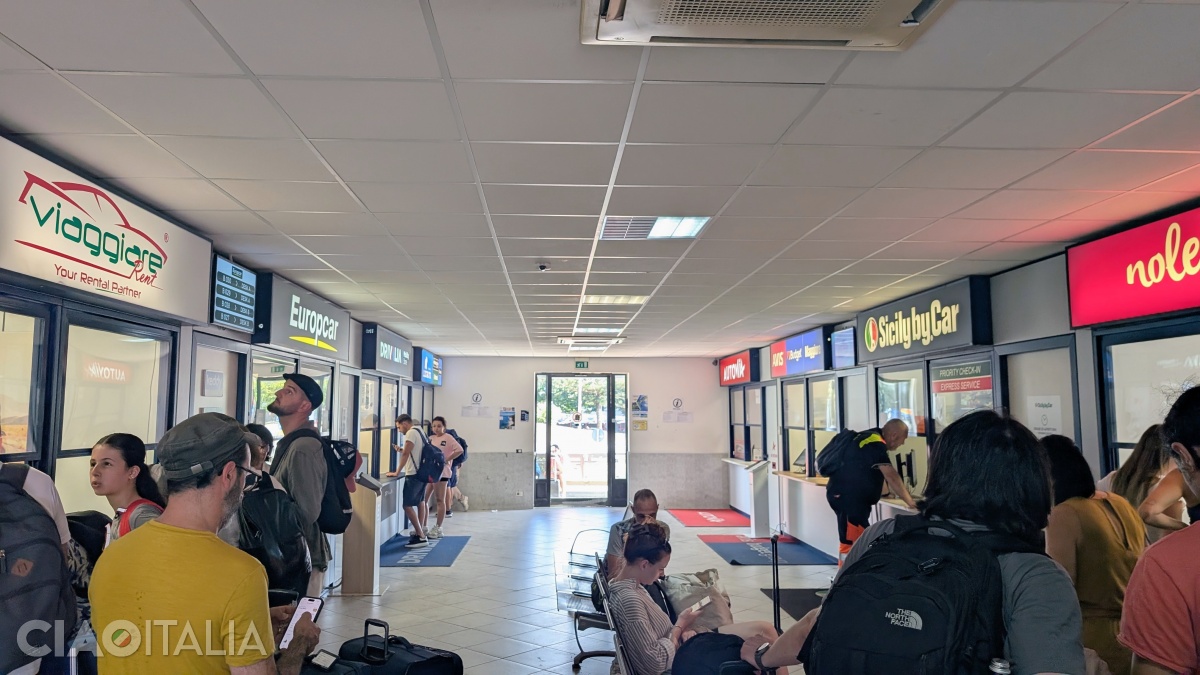 The car rental companies' offices are located in a separate building from the airport.