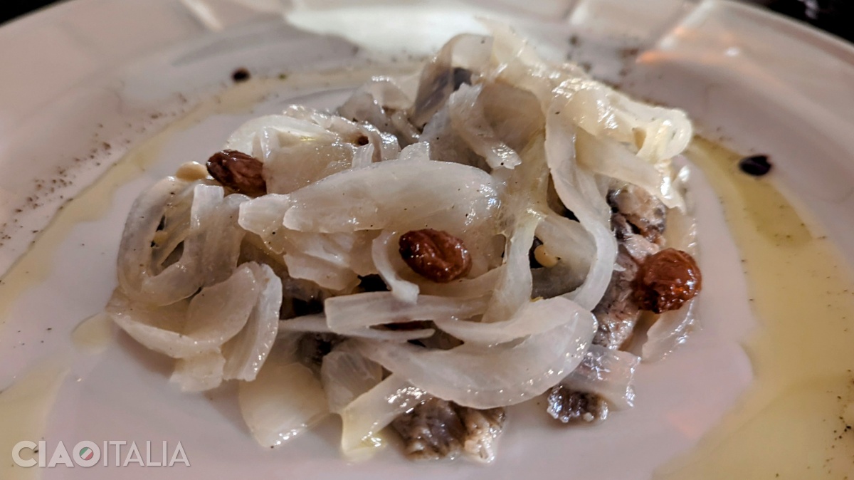 Sarde in saor is made with sardines, onions, raisins, and pine nuts.