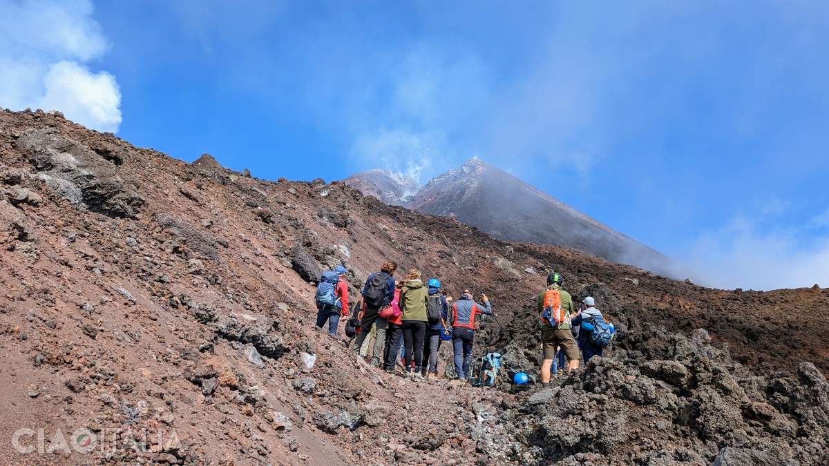 In the distance, the Bocca Nuova crater can be seen, fuming.
