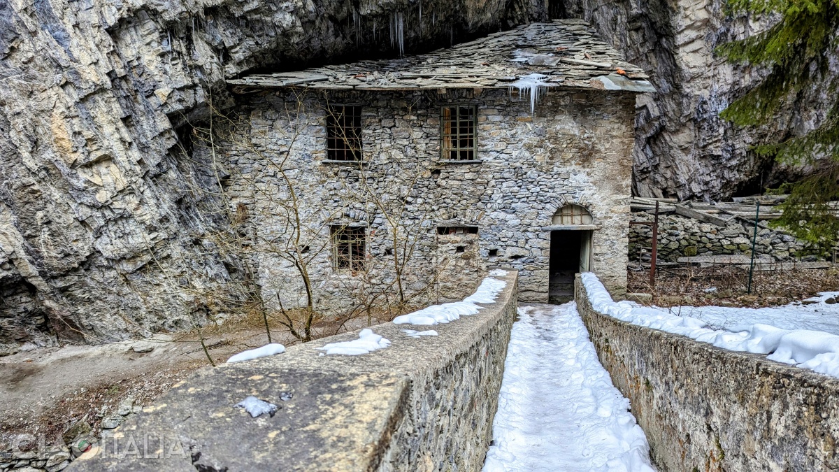 At the end of the bridge there is a stone house.