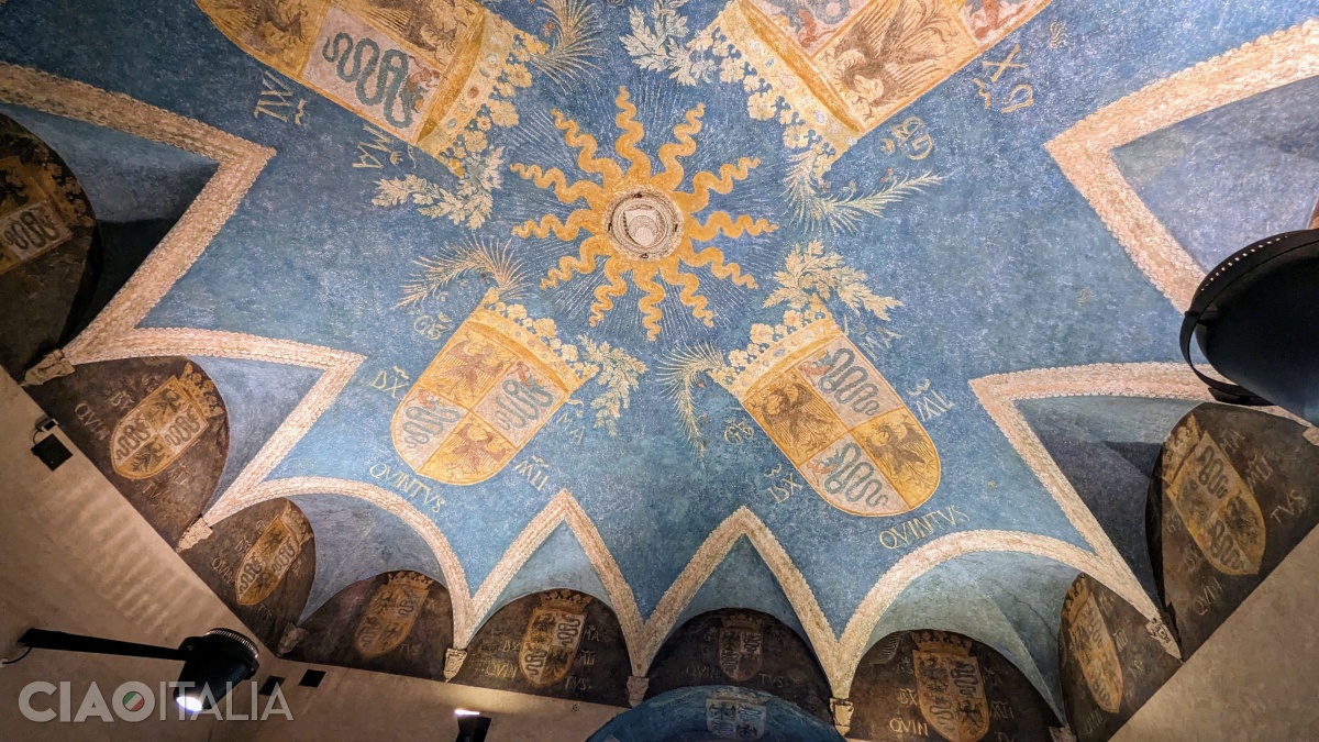 The ceiling of the hall is decorated with the coats of arms of Galeazzo Maria Sforza.