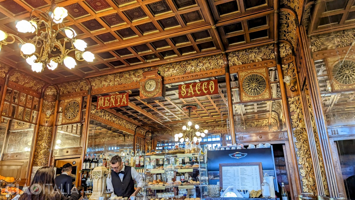 The interior of the café is decorated with carved wooden panels.