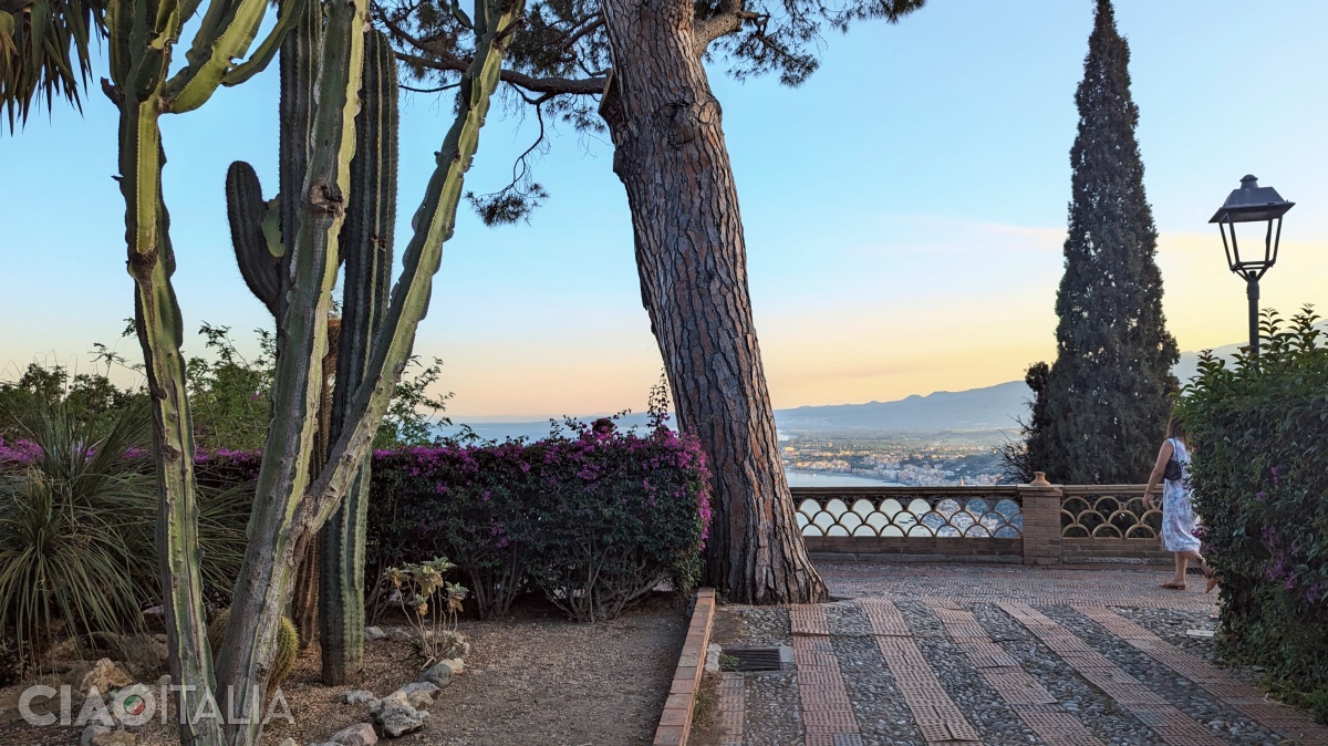 The panoramic walkway is lined with bougainvillea flowers.
