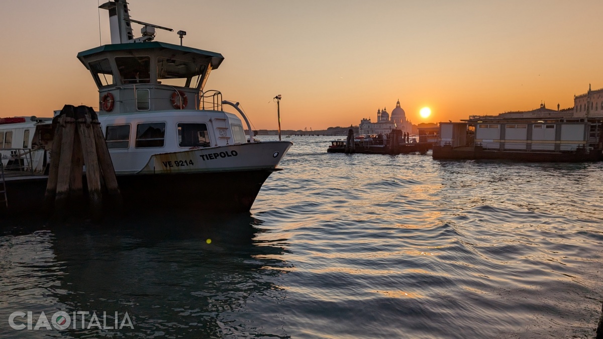 The sun sets behind the Basilica of Santa Maria della Salute.