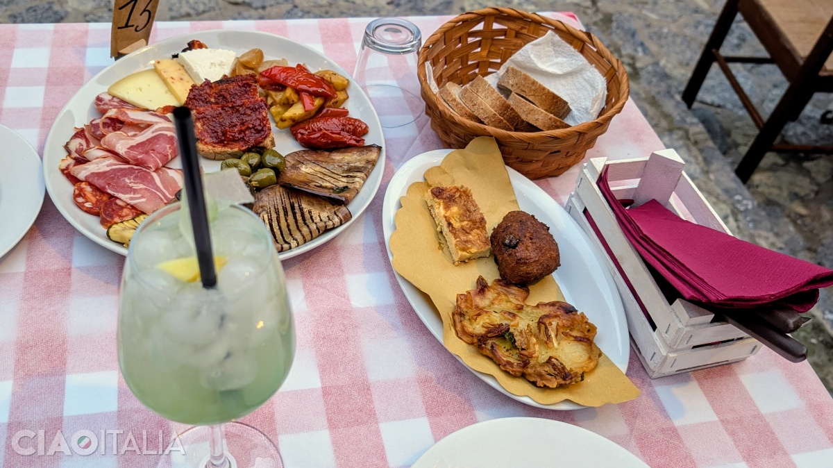 Traditional appetizer: bruschetta with 'nduja and Calabrian spritz (made with citron syrup - Citrus medica).