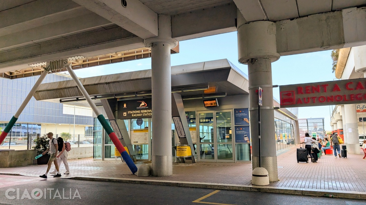 The train station is located to the left of the terminal.
