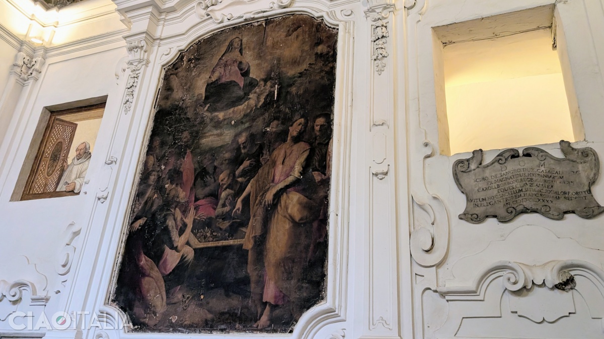 On the left side of the wall, Vasari painted an Olivetan monk opening a window.