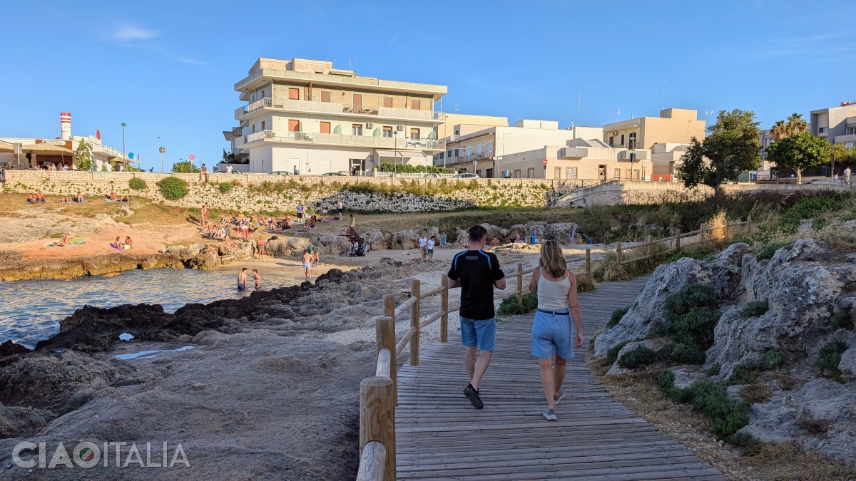 A wooden walkway leads down to Porto Bianco Beach.