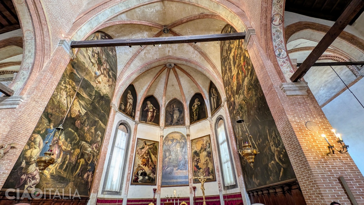 The altar is adorned with paintings by Tintoretto.