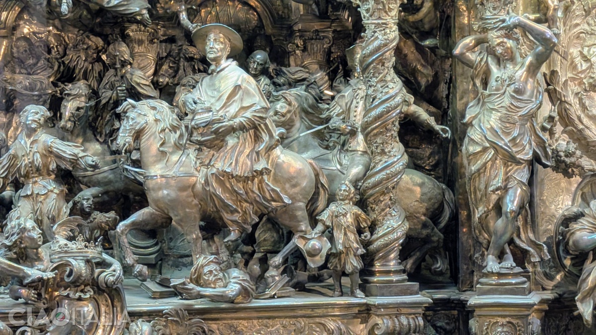 To the lower right, at the horse's feet, is the self-portrait of the artist who created the silver plate that adorns the altar.