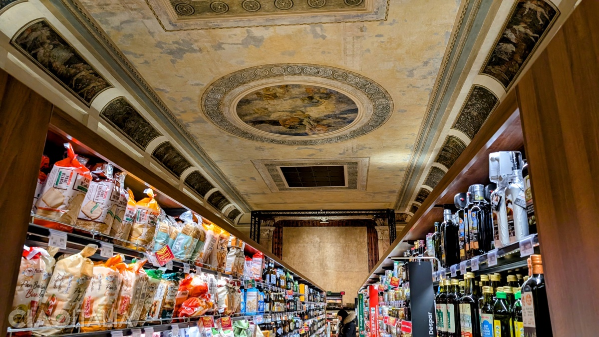 The ceiling preserves early-20th-century frescoes, and at the back the stage can still be recognized.