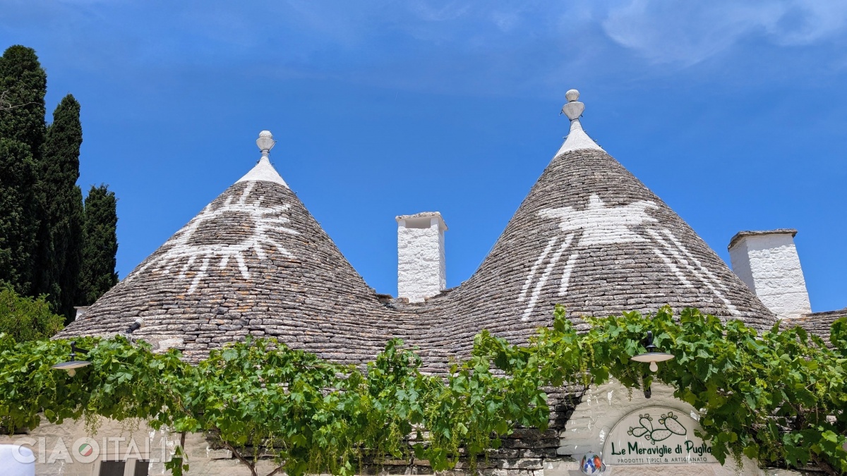 The roofs bear symbols that serve a protective or identifying purpose.