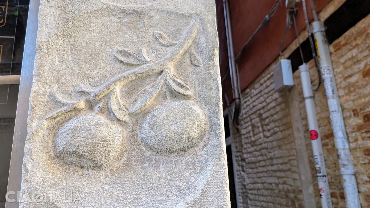 On the column at number 374, two peaches hang from a branch.