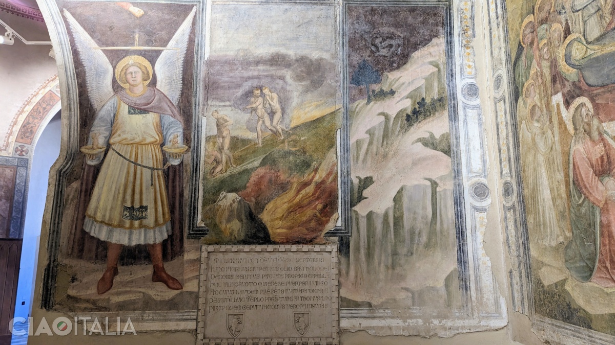 To the right of the image of Saint Michael, a plaque indicates the year of construction and the names of the founder and the painter.