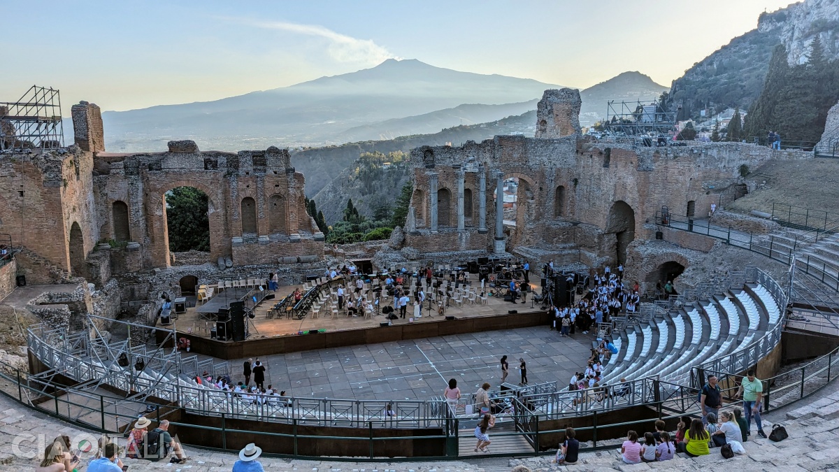 The orchestra is the semicircular space below located between the stage and the seating tiers.