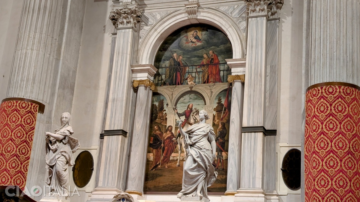 The altarpiece was painted by Carpaccio. The statues flanking it symbolize two Christian virtues: Faith and Fortitude.