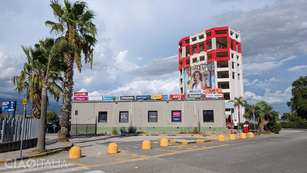 The car rental companies are located in a building opposite the airport.