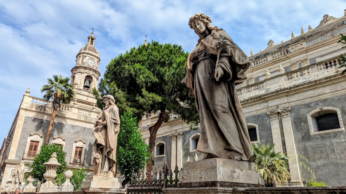 The fence of the cathedral is adorned with statues.