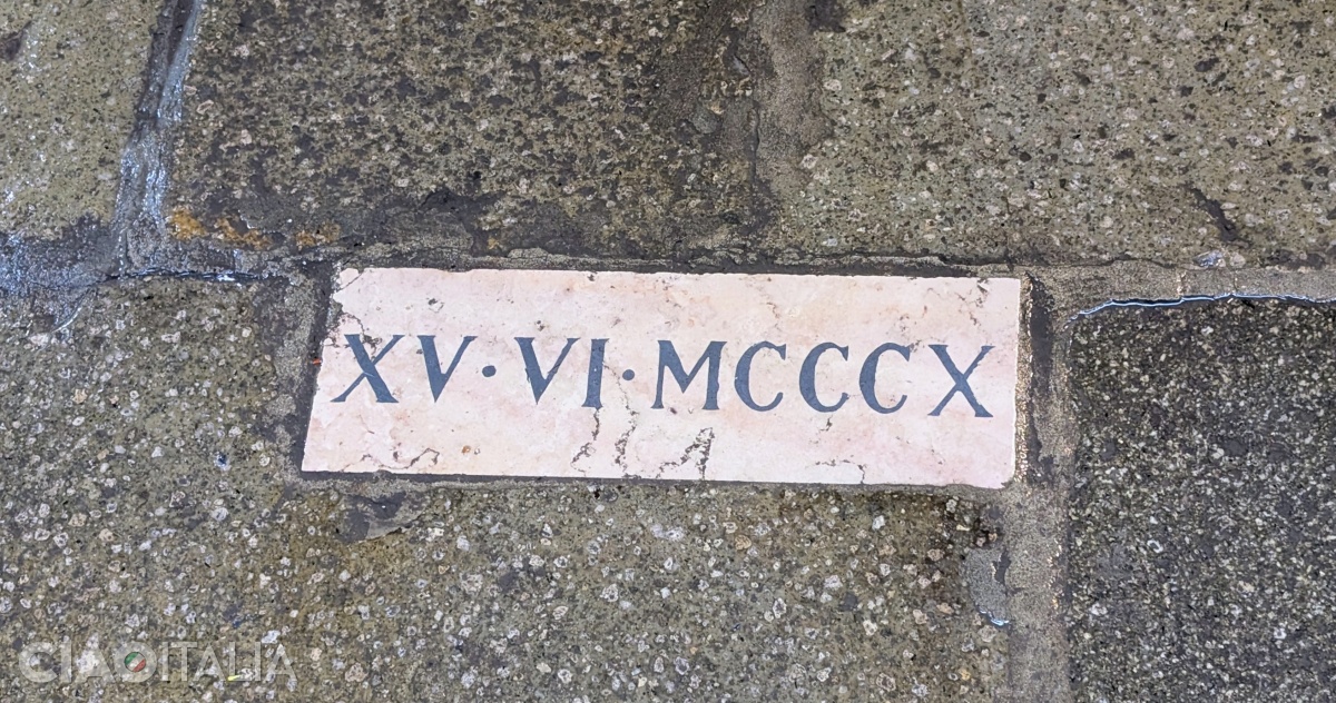 The white stone in the pavement marks the spot where the mortar is said to have fallen.