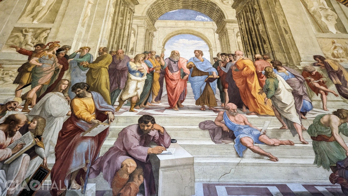 The "School of Athens". In the center are depicted Plato (pointing toward the heavens and possibly portrayed with the face of Leonardo da Vinci) and Aristotle (pointing toward the earth). The thoughtful figure in the lower part is Heraclitus, but it is believed that he bears the face of Michelangelo, whom Raphael admired. The young figure on the left, dressed in white with long hair, is thought to be a self-portrait of the artist.