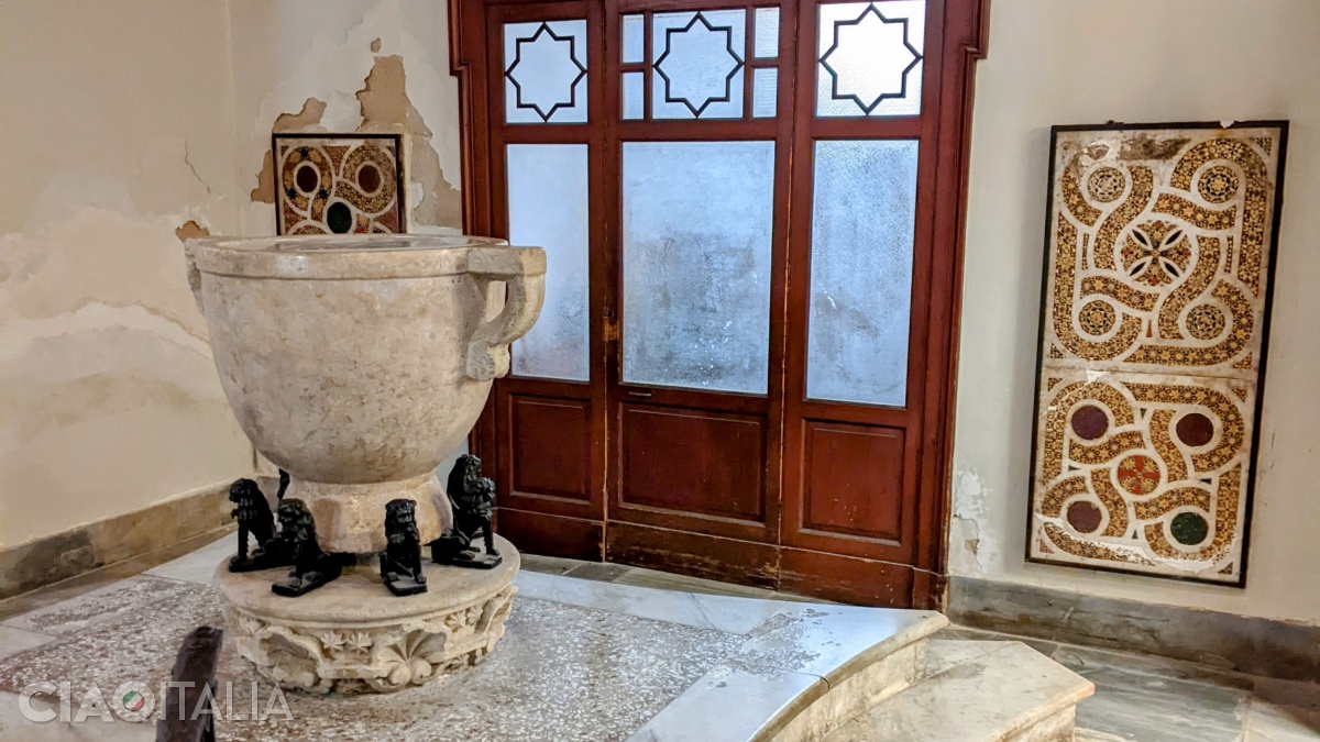The marble baptismal font and fragments of mosaic from the Norman period (12th century), in the Baptistery Chapel