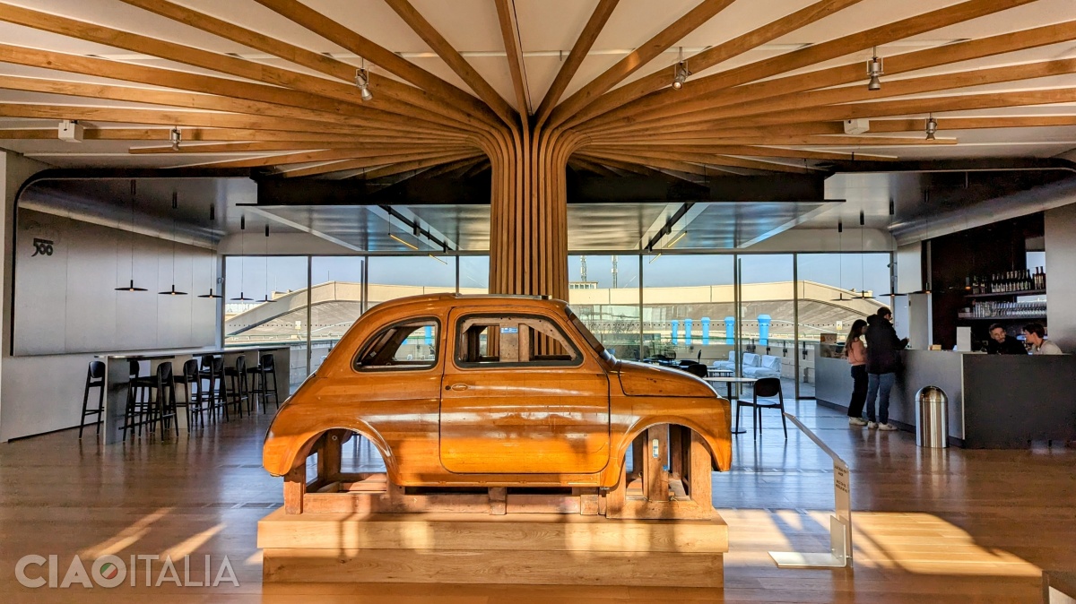 In the center of the hall, beneath the tree made of recycled wood, is the mold used for the body of the 1950s Fiat 500 car.