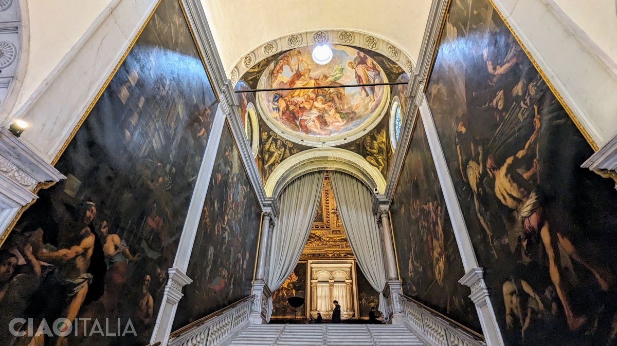 The staircase is bordered by paintings by Pietro Negri on the left ("The Virgin Saves Venice from the Plague") and Antonio Zanchi on the right ("The Virgin Appears to Those Suffering from the Plague").