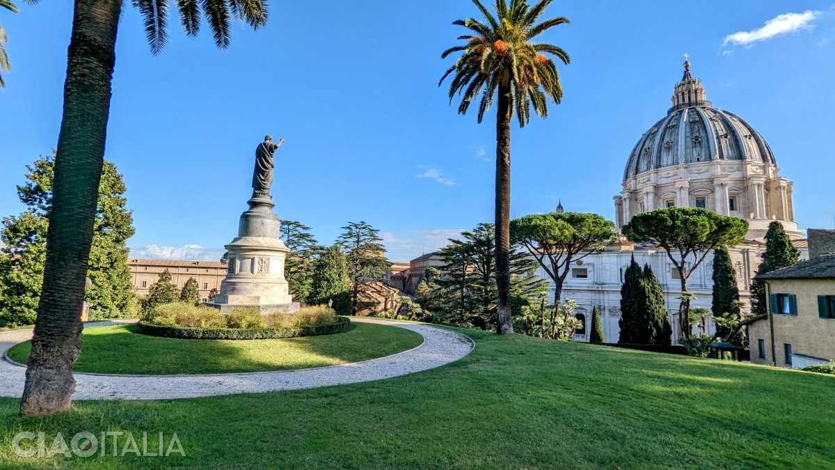 The statue of Saint Peter facing toward the dome of the Vatican is very beautiful.