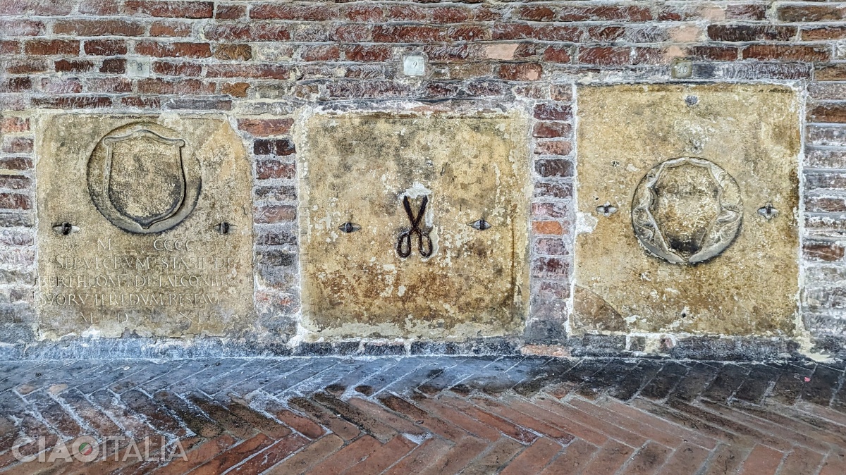 The tailor's tombstone features a pair of scissors in the center.