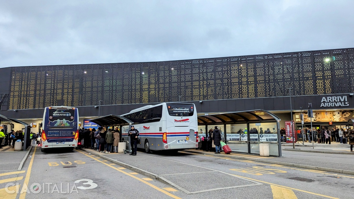 The shuttle bus station is in front of the terminal (as you exit, on the right).
