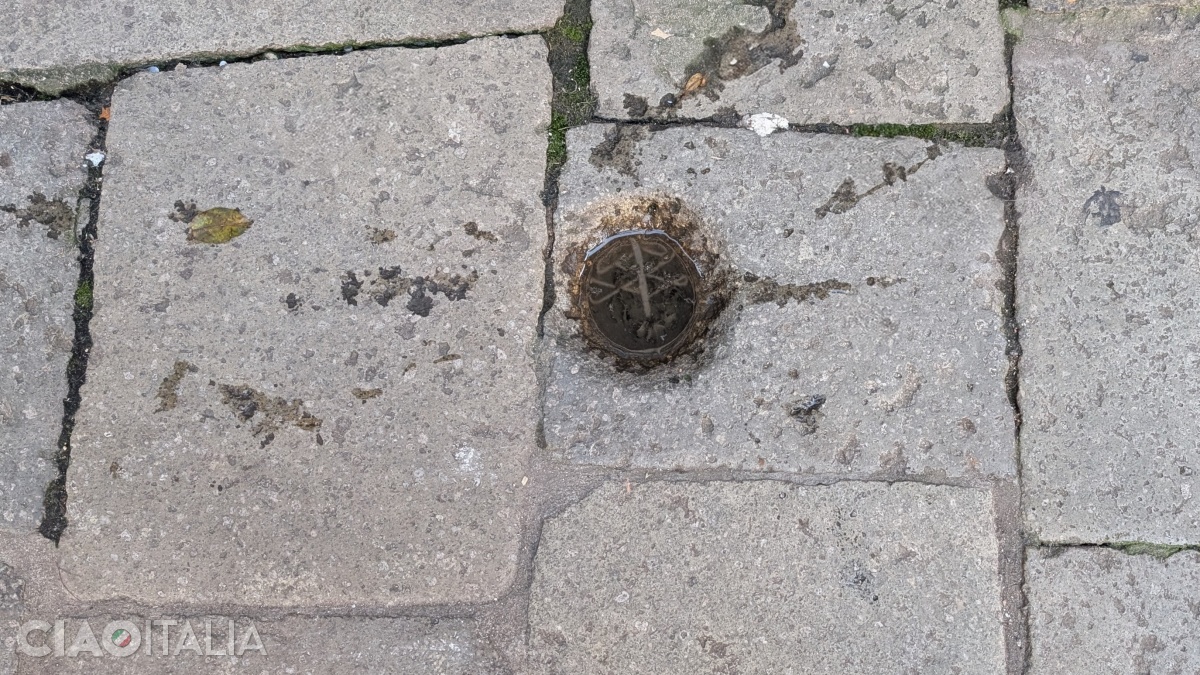 The mark in front of the Alle Due Colonne pharmacy