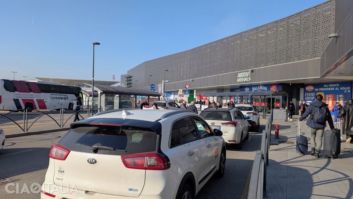 The taxi rack is in front of the airport.