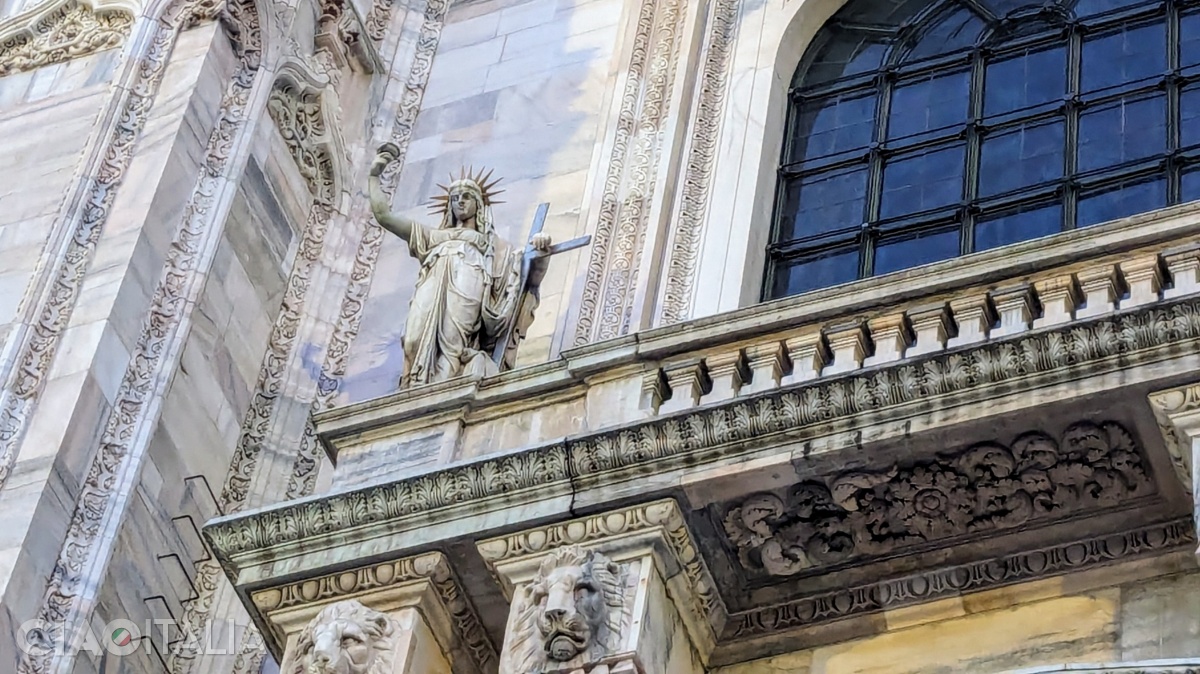 The statue on the facade of the Cathedral is similar to the Statue of Liberty in New York.