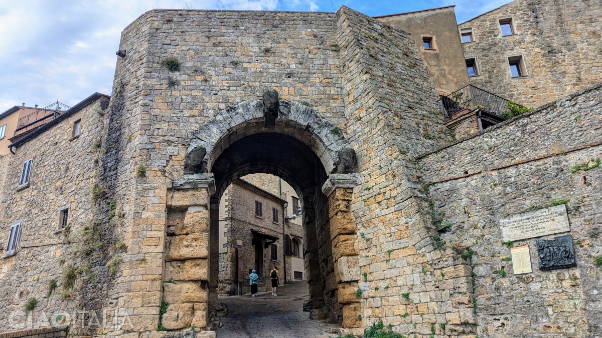 The view from outside the walls. The three figures on the gate may represent protective deities of the city.