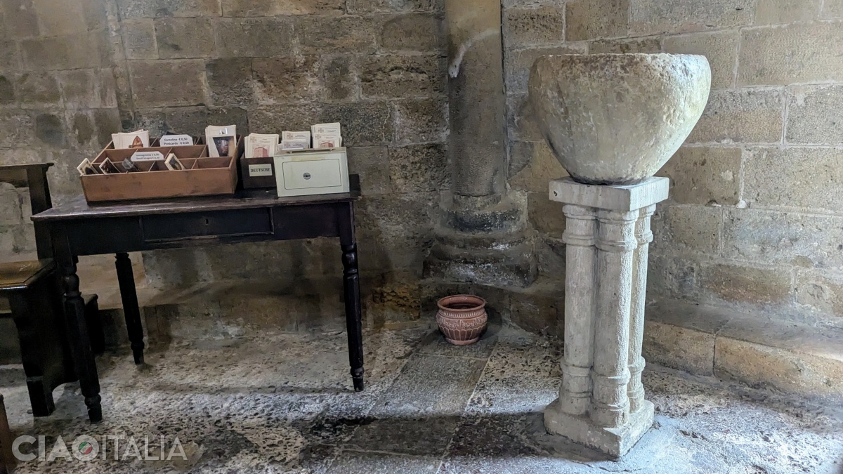 The holy water basin comes from an Etruscan funerary monument.