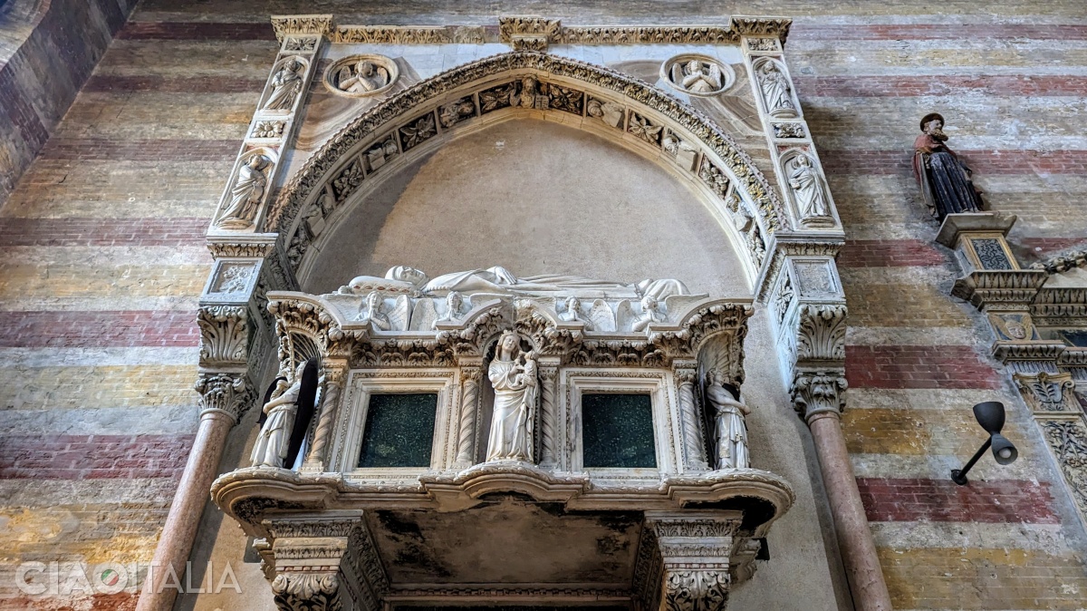 The tomb of Jacopo da Carrara is decorated with statues of angels and saints.